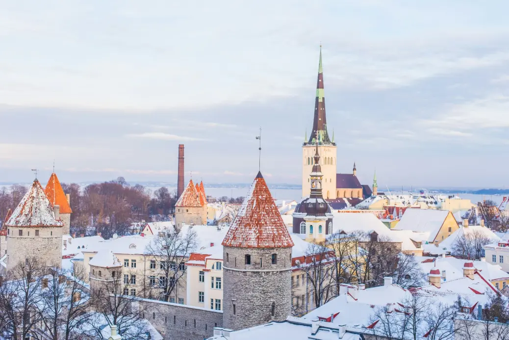 snow covered brown, white, and gray concrete castle under cloudy skies
