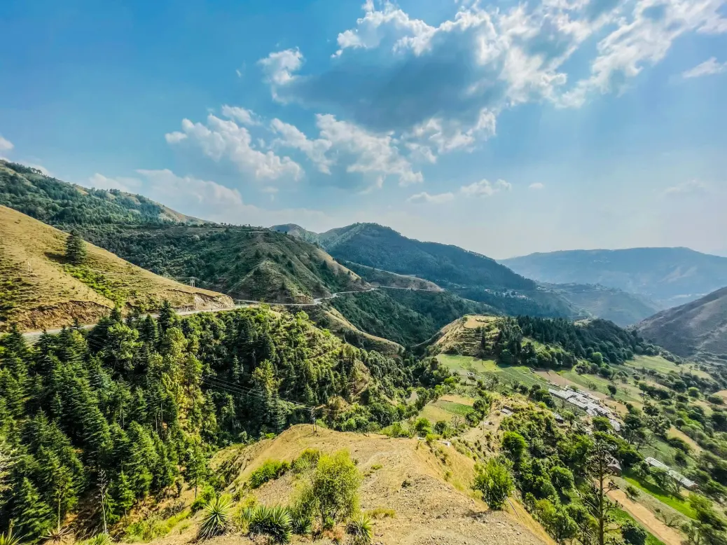 a scenic view of a valley and mountains