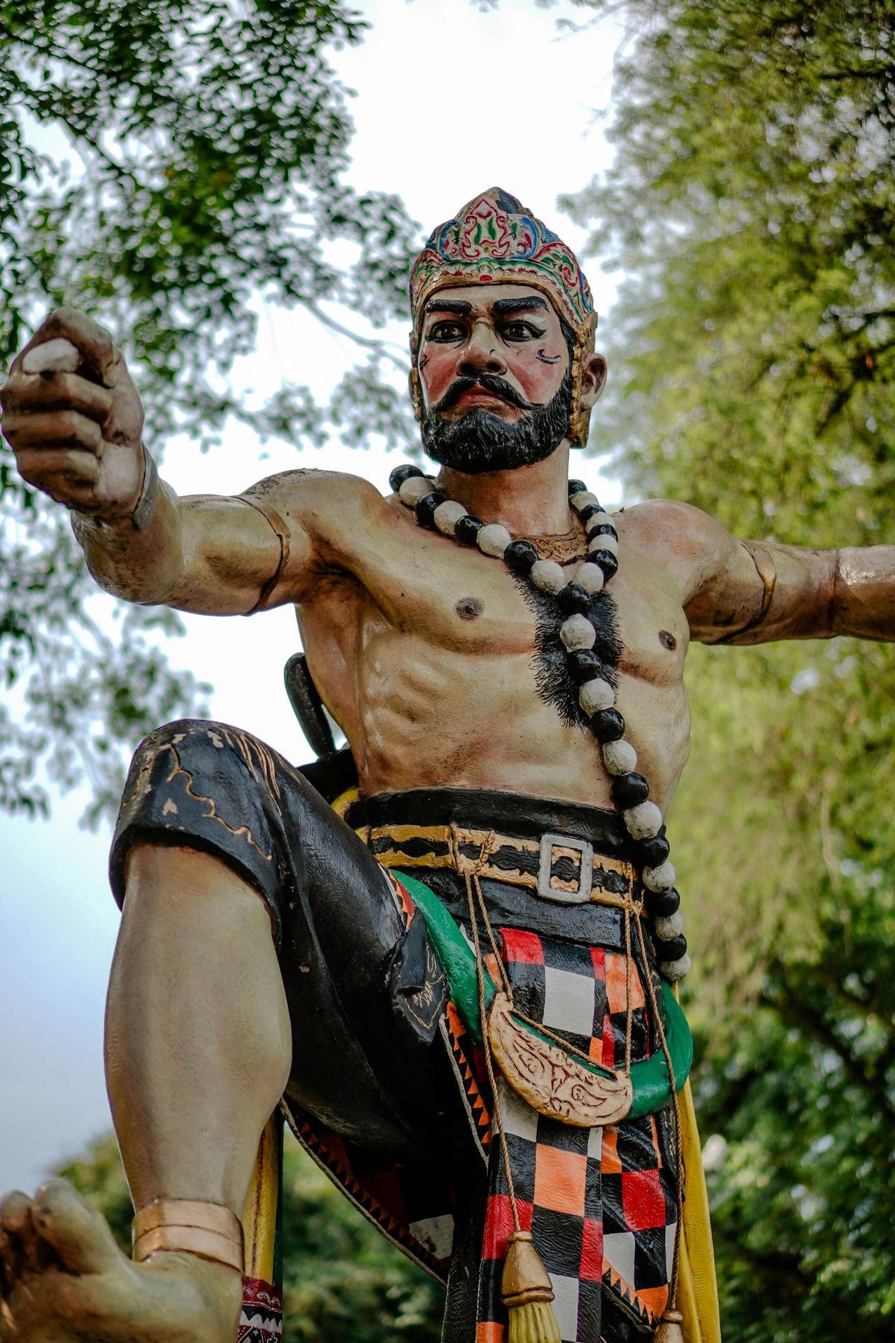 a statue of a man with a beard and beads