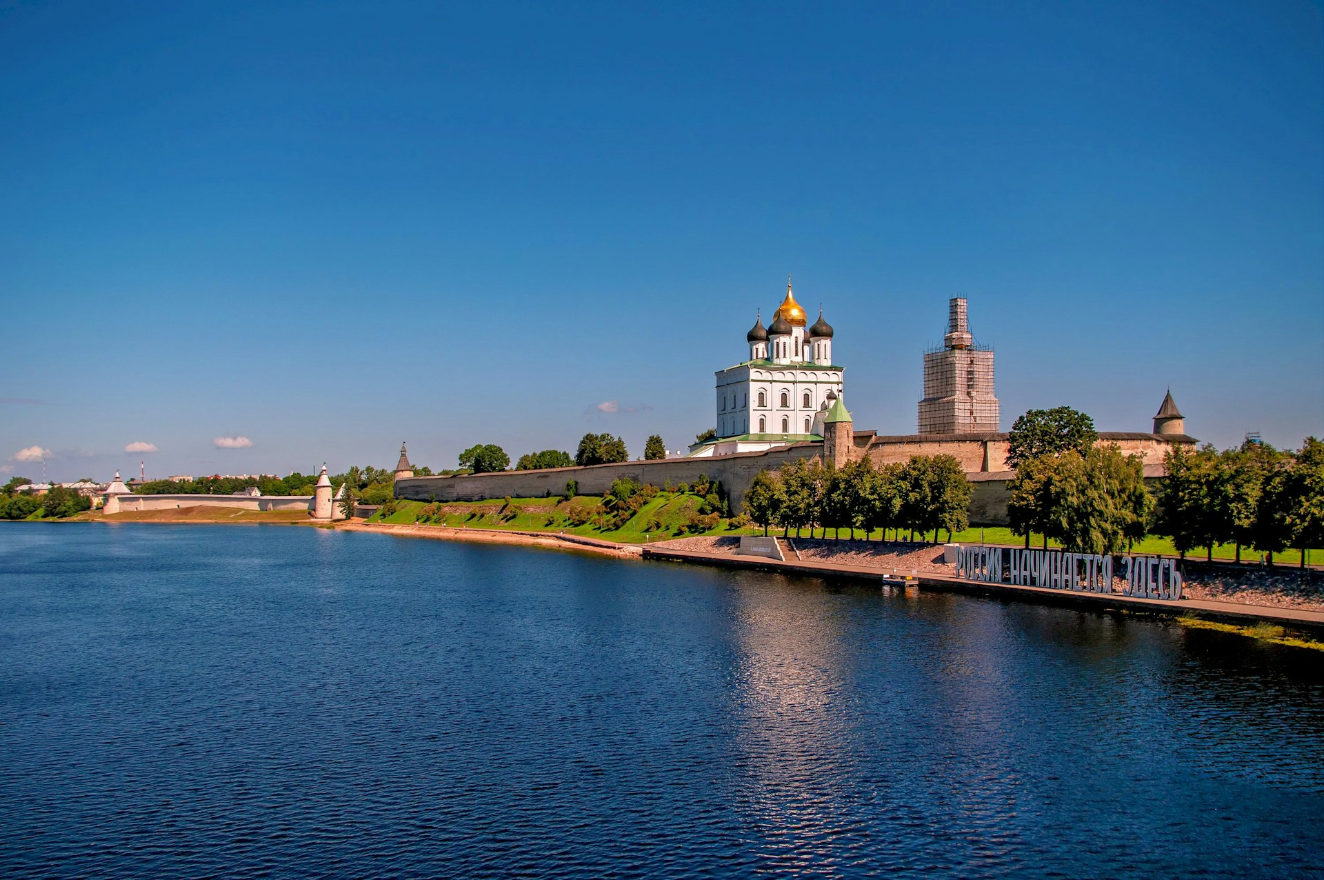 A beautiful castle overlooks a serene river.